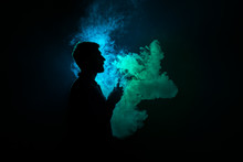 The Man Smoke A Cigarette On The Dark Background