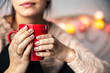 © serbogachuk - Woman's hand holding a red cup of coffee. With a beautiful winter manicure. Drink, fashion, morning