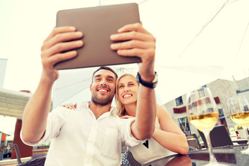 Poster - happy couple taking selfie with tablet pc at cafe