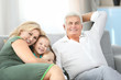 © Africa Studio - Grandparents with granddaughter on couch