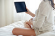© Syda Productions - close up of pregnant woman with tablet pc at home