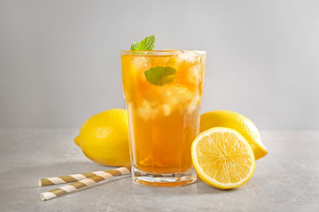 Poster - Glass of iced tea with lemon slices and mint on table