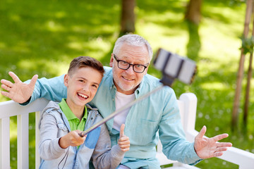 Sticker - old man and boy taking selfie by smartphone