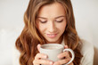 © Syda Productions - close up of happy woman with coffee cup at home