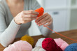 © Syda Productions - woman pulling yarn up into ball