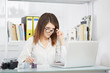 © Stocked House Studio - Young woman photo reporter sitting in front of desktop computer