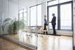 © Westend61 - Businessman and woman in office shaking hands