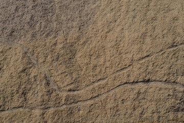 sandstone. texture, background. yellow sandstone with incised lines.