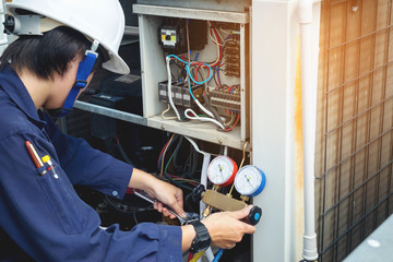 Technician is checking air conditioner