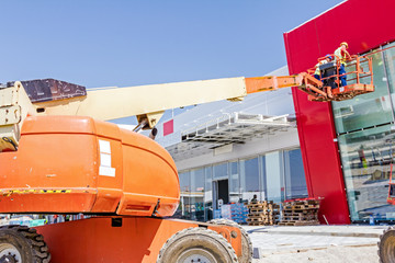 Working in elevated cherry picker on building site