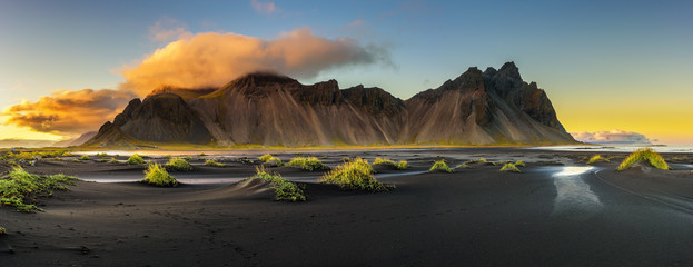 sunset above vestrahorn and its black sand beach in iceland