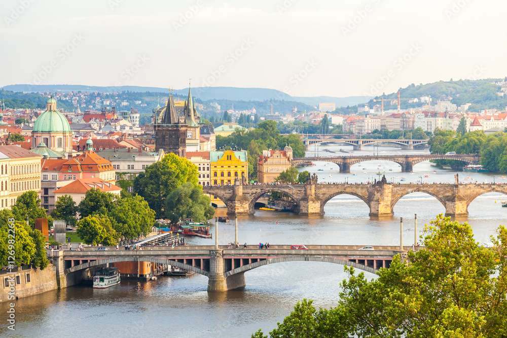 Panorama of the old part of Prague from the Letna park. Beautiful view on the bridges over the river Vltava at sunset. Old Town architecture, Czech Republic. - obrazy, fototapety, plakaty 