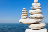 Fototapeta Desenie - Concept of balance and harmony. White rocks zen on the sea.