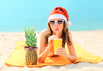 Christmas portrait pretty young woman in red santa hat with pine