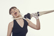 Terrified woman shouting while pulled aside and strangled by umbrella handle around her neck over bright background. Disillusioned upset lady strangling herself by the umbrella handle. Fashion drama.