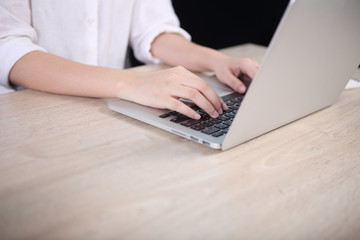 Poster - Business woman using laptop on wooden desk