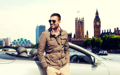 Wall Mural - happy man near cabriolet car over london city