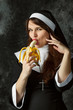 attractive nun holding a banana and bites him on a dark background
