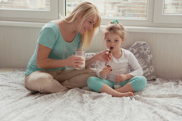 Mom and daughter on the bed at home