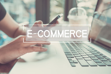 Wall Mural - business hand typing on a laptop keyboard with e-commerce homepage on the computer screen digital em