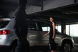 © Drobot Dean - Man robber threatening with gun to businesswoman on car parking