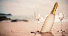 Champagne Bottle And Two Glasses On Sand