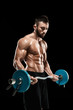 © nazarovsergey - muscular man lifting weights over dark background