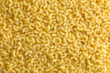 Pasta raw closeup background. Delicious dry uncooked ingredient for traditional Italian cuisine dish. Textured variety shapes. Top view. Copy space