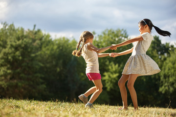 Two girls dancing in a circle