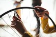 © Wavebreak Media - Mechanic examining a bicycle wheel