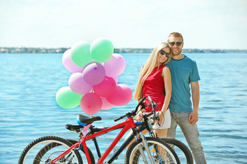 Poster - Happy couple with bicycles on the beach