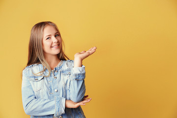 Beautiful teenager girl on yellow background