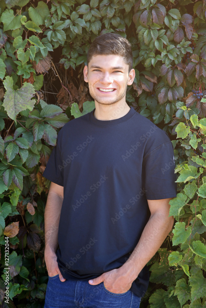 Handsome man on green leaves background