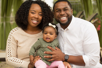 Wall Mural - Happy family. Mother father and baby girl. 