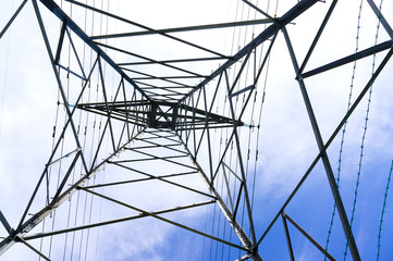 Silhouette shot of electricity pylons with cloudy sky