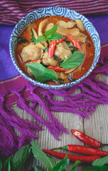 Wall Mural - Thai Chicken Red Curry on Thai Fabric and  Old Wooden Background