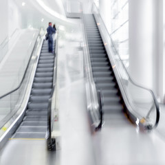 Wall Mural - people on moving escalator motion blur