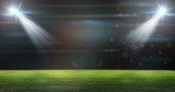 Fototapeta Sport - Green soccer field, bright spotlights,
