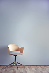 Simple interior with stool on blue wall background