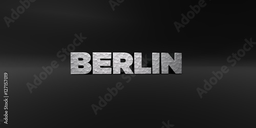 Photo BERLIN - hammered metal finish text on black studio - 3D rendered royalty free stock photo
