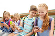 © Syda Productions - elementary school students with smartphones