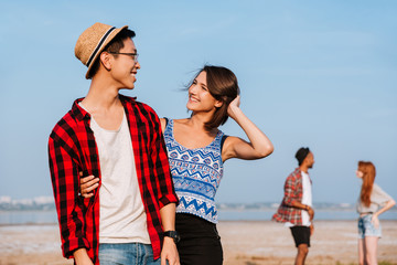 Wall Mural - Two happy young couples standing and smiling