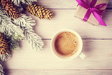 Cup Of Coffee And Gift Box Over Vintage Xmas Background