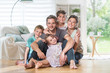 © jackfrog - At home,  cheerful family sitting on floor in the living-room.