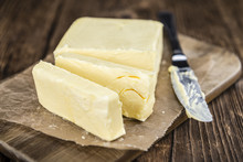Piece Of Butter On Wooden Background (selective Focus)