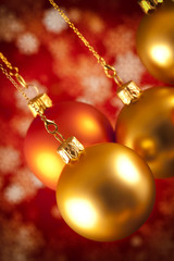 Christmas baubles and white snowflakes on red background