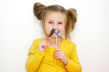 Adorable little girl holding mustache party accessory