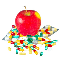 apple and pills isolated on white background