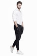© dorriss - Young handsome man in black trousers and white shirt takes a step