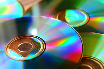 Many cd with reflections on a table. Suitable to be used like a background. Tilt-shift effect applied.